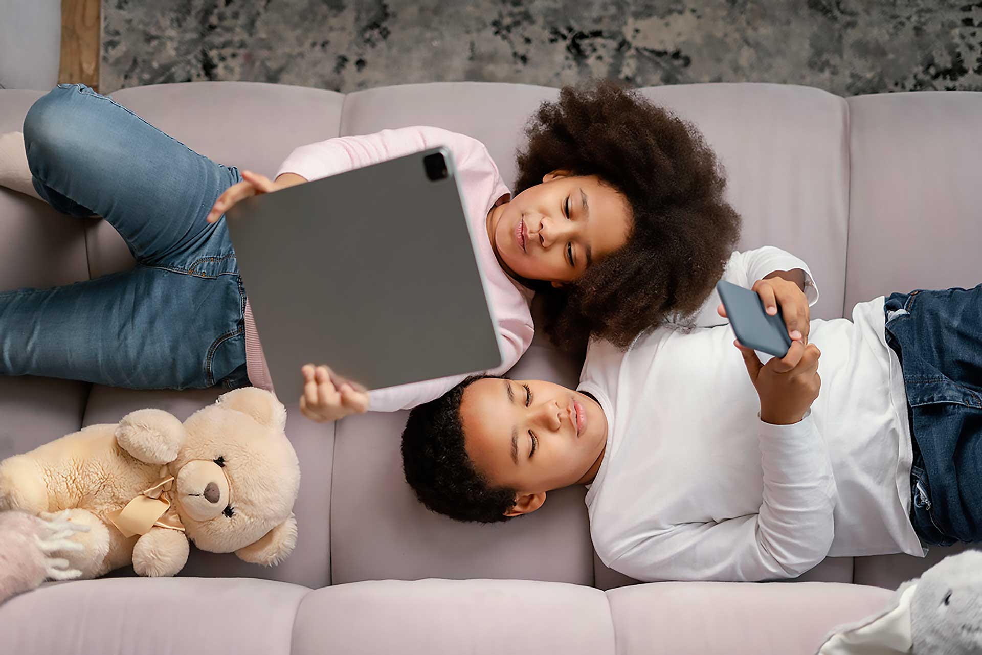 Family relaxing on a sofa with a tablet