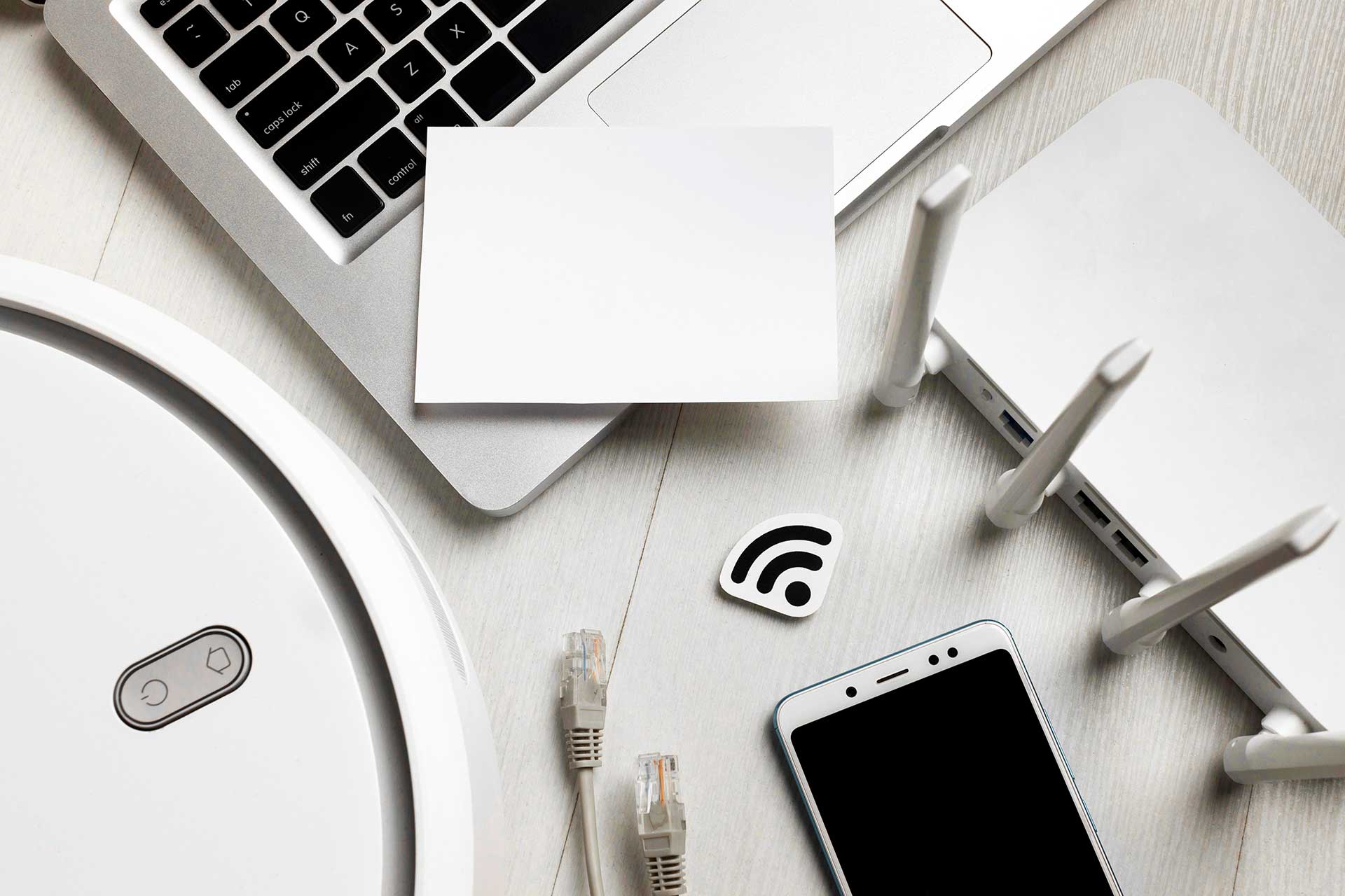 Desk with a laptop, router and phone